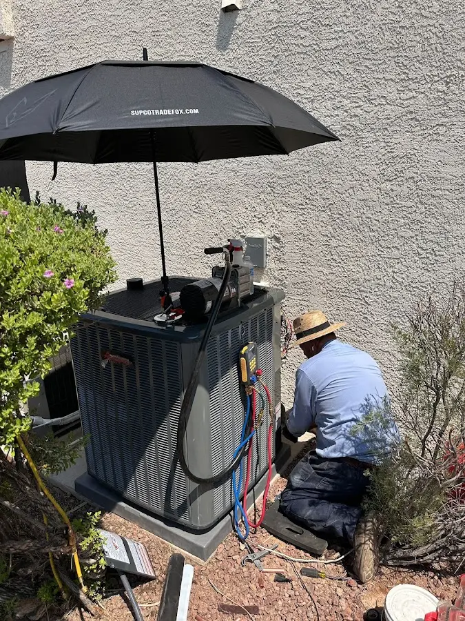 HVAC technician performing outdoor AC maintenance in Biloxi