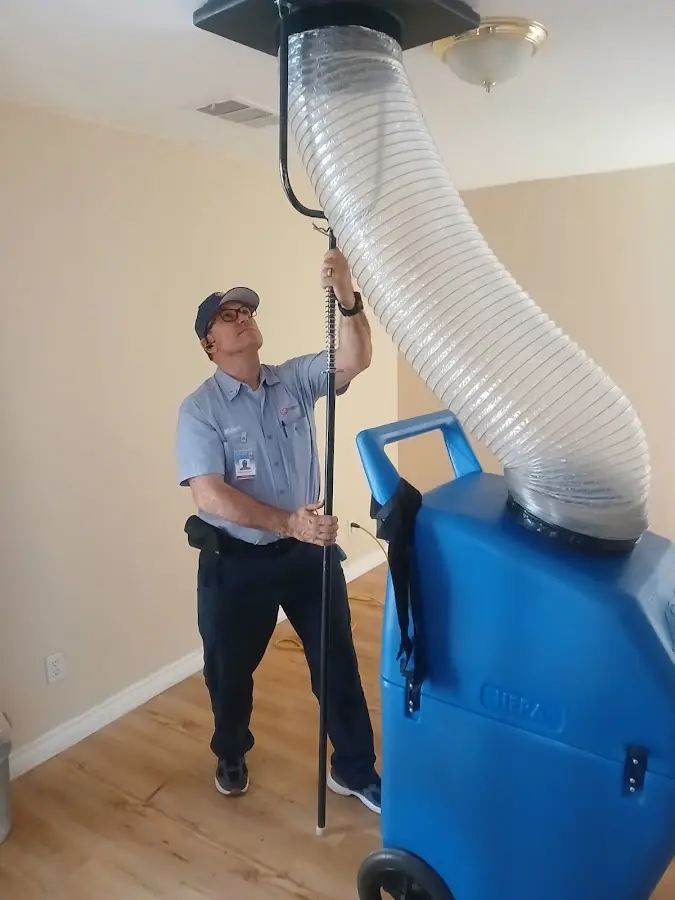 Furnace Tune-Up technician using HEPA equipment in Biloxi